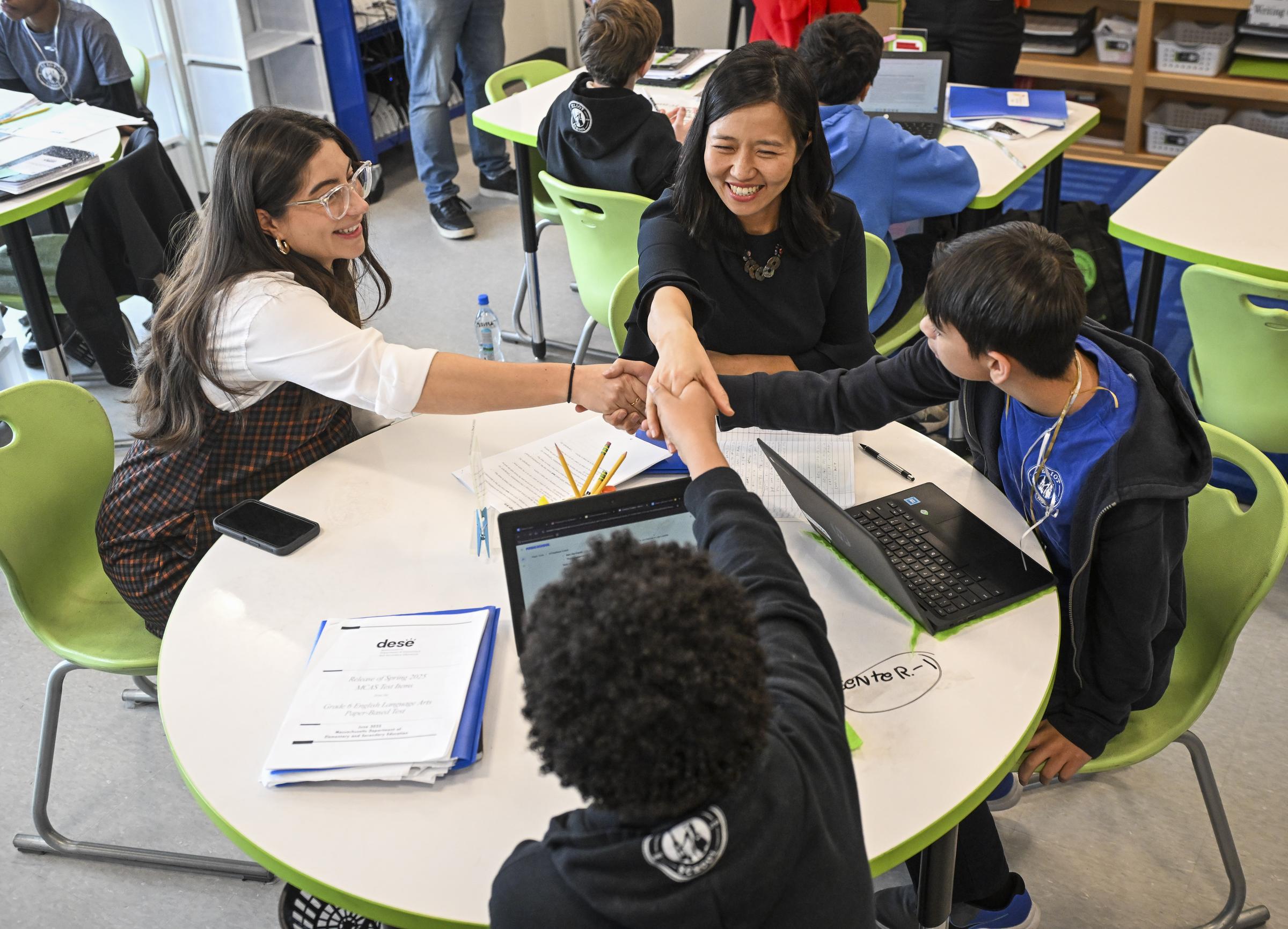 Mayor Wu laughing with students and teacher at a BPS classroom visit