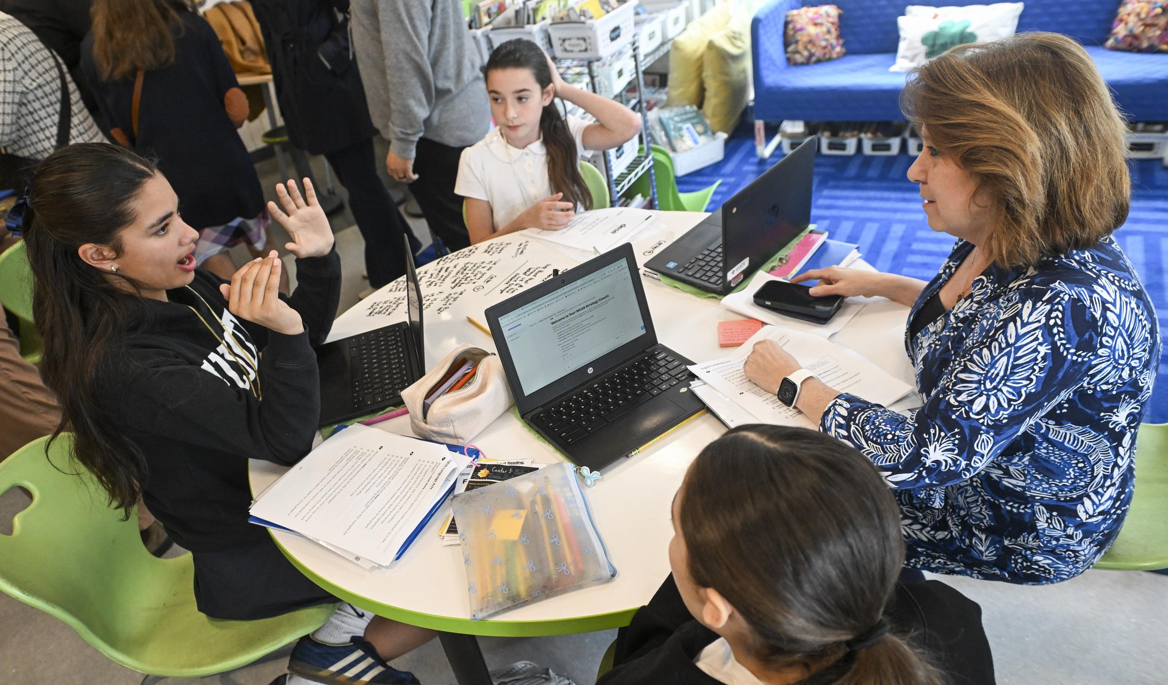 Students and teacher collaborating on AI learning at a BPS classroom